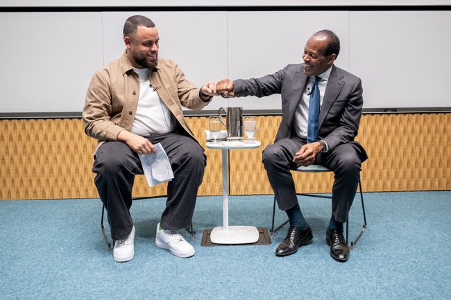 2 event speakers converse during lecture
