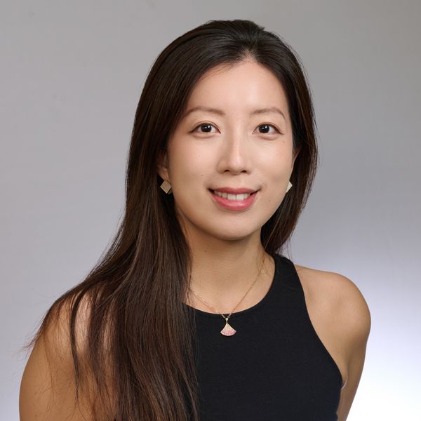 Shows Mingyan Ma, who has long dark hair and is wearing a sleeveless black top